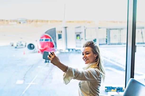 istock Woman take selfie at airport 1211454096