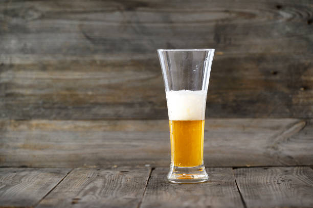istock Glass beer on wood background with copyspace. 1211454996