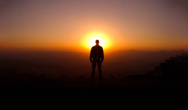 istock A man in the top of a mountain looking 1211455240