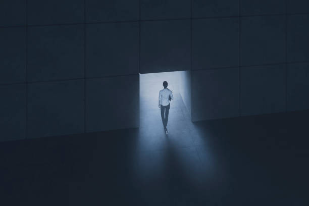 istock Young woman walking through concrete passage 1211456720