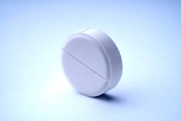 istock Closeup of one tablet on a white background with texture. 1211458442