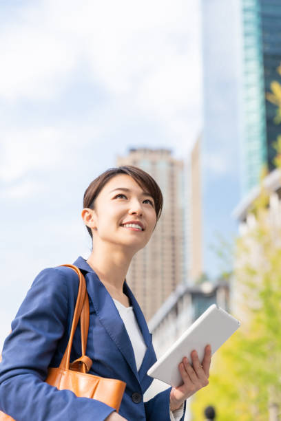 istock asian woman who see a tablet computer 1211463441