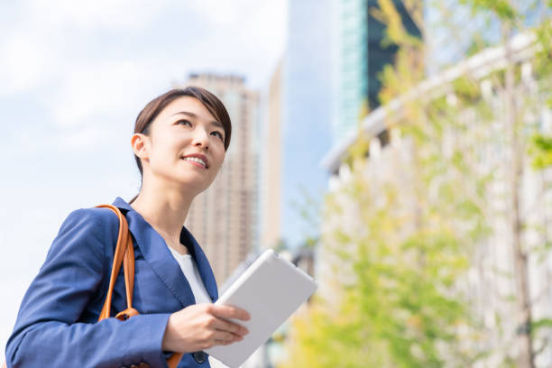 istock asian woman who see a tablet computer 1211463479