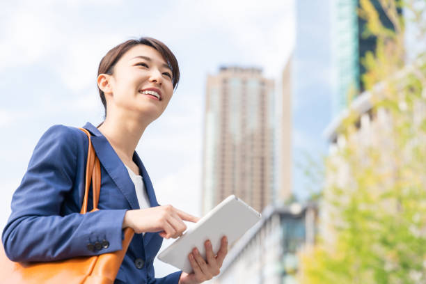 istock asian woman who see a tablet computer 1211463485