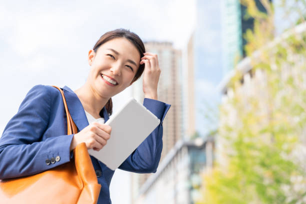 istock asian woman who see a tablet computer 1211463508