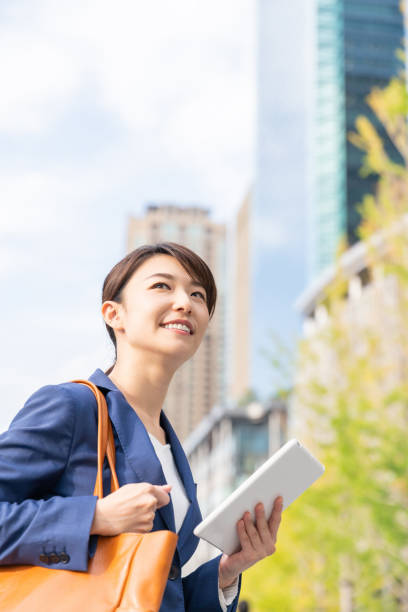istock asian woman who see a tablet computer 1211463516