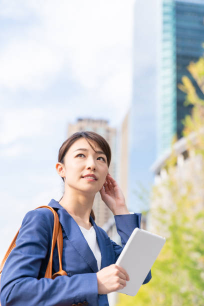 istock asian woman who see a tablet computer 1211463540