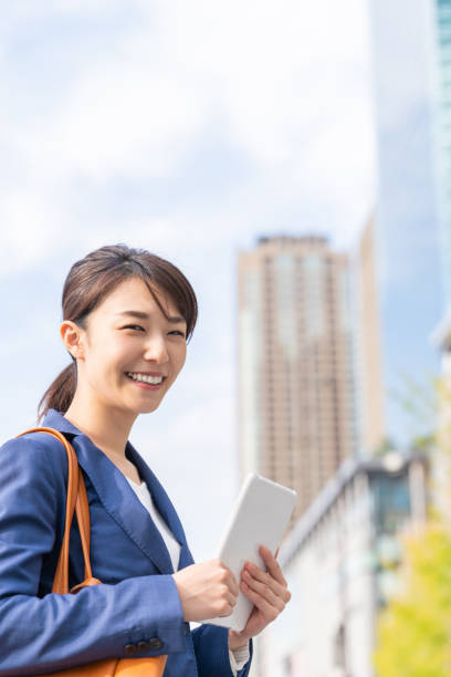 istock asian woman who see a tablet computer 1211463557