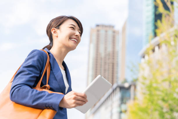 istock asian woman who see a tablet computer 1211463590