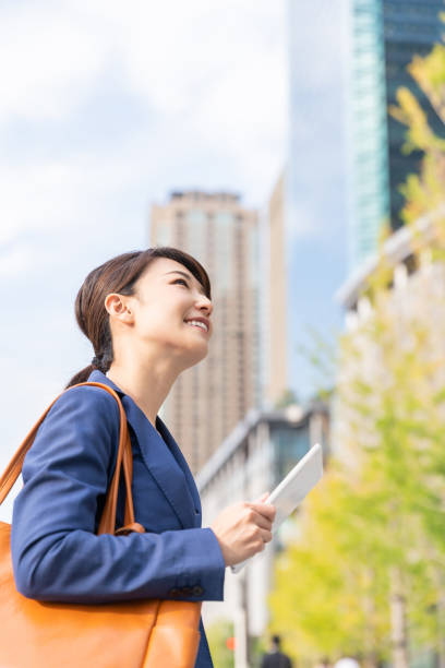istock asian woman who see a tablet computer 1211463617