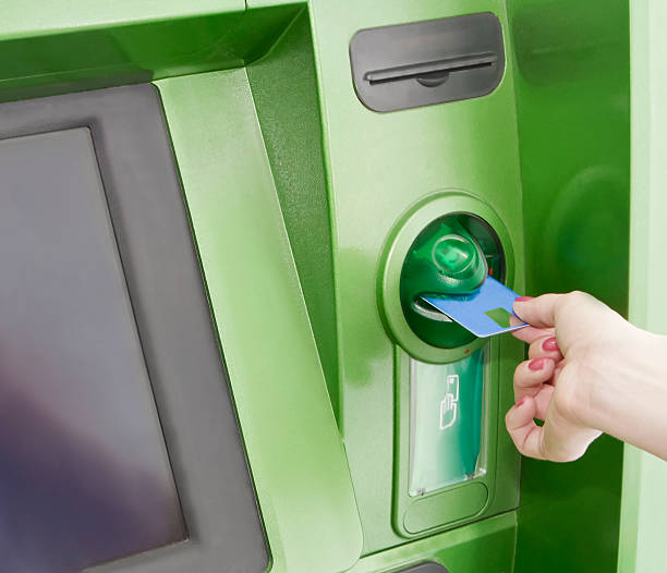 istock Female inserts a plastic card in the ATM 121146364