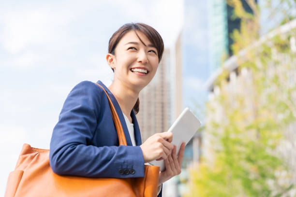 istock asian woman who see a tablet computer 1211463651
