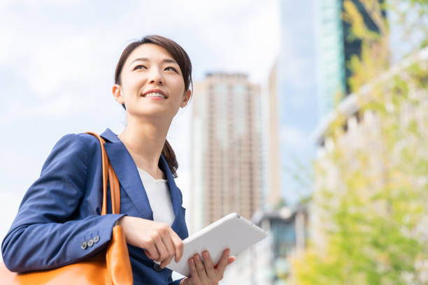 istock asian woman who see a tablet computer 1211463665