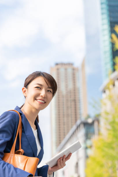 istock asian woman who see a tablet computer 1211463669