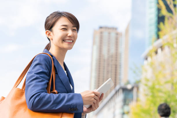 istock asian woman who see a tablet computer 1211463728