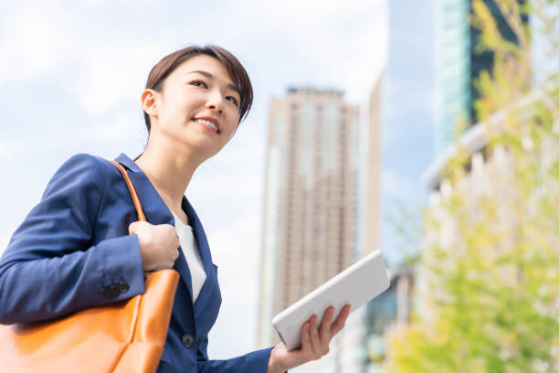 istock asian woman who see a tablet computer 1211463733