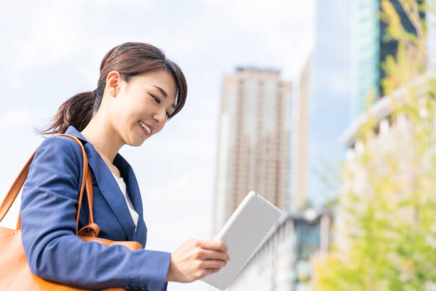 istock asian woman who see a tablet computer 1211463747