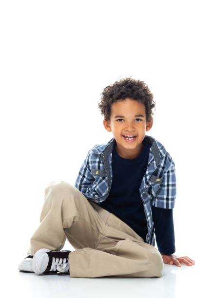 istock Boys sitting on floor in front of white background 1211468361