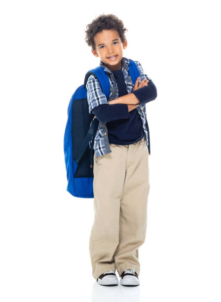 istock Boys student standing in front of white background and holding book 1211468363