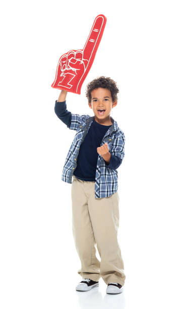 Boys fan - enthusiast standing in front of white background and holding foam hand stock photo