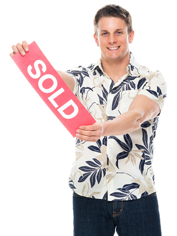 Portrait of aged 30-39 years old with short hair caucasian male standing in front of white background wearing pants who is cheerful and holding sign