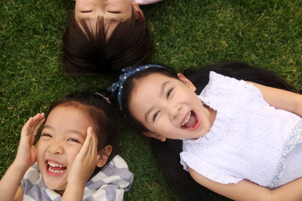 istock The happy children were playing on the grass 1211472822