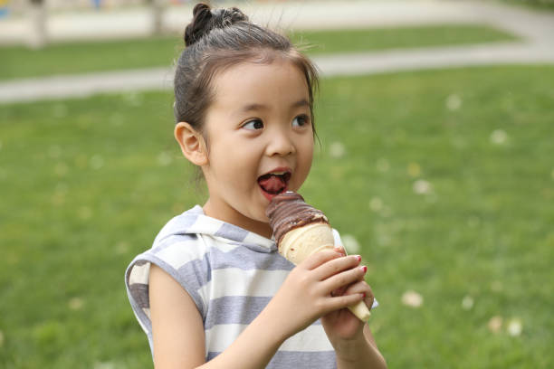 istock The little girl eats ice cream 1211472838