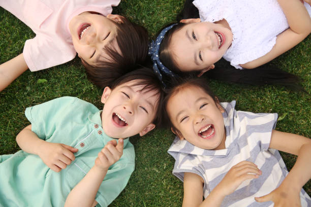 istock The happy children were playing on the grass 1211472840