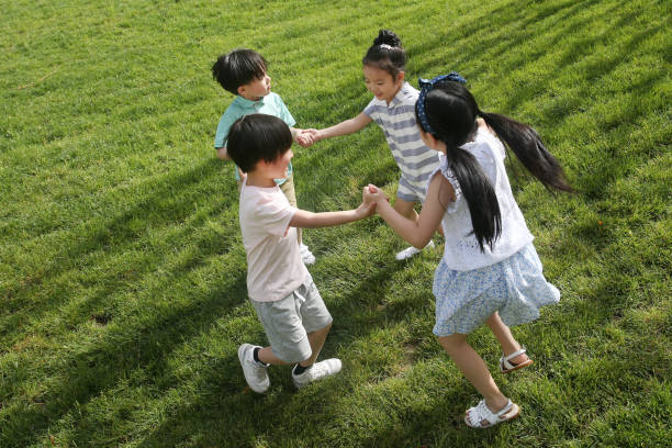 The happy children were playing on the grass