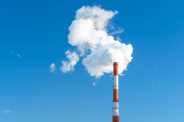 istock industrial smoke from a chimney in the blue sky. space for text, copy space 1211478088