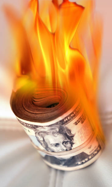 istock rubber banded burning American twenty dollar bill pile 1211479252