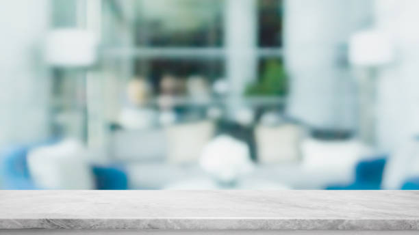istock Empty white marble stone table top and blur glass window interior restaurant banner mock up abstract background - can used for display or montage your products. 1211480762