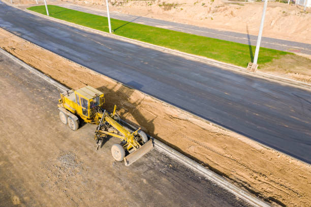 istock road grader on road construction site. aerial view 1211481543