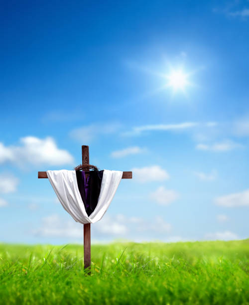 istock Religious cross on green grass landscape 1211481644