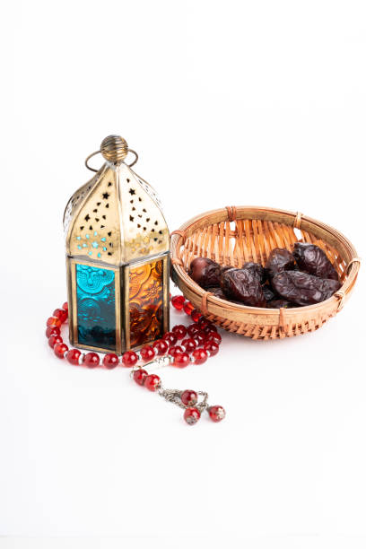istock Ramadhan concept. Arabic lantern and dates isolated against white 1211485317