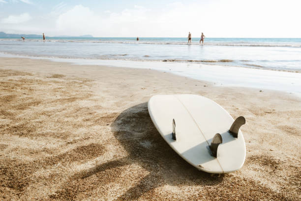 istock Surfboard on beach background and people. 1211485668