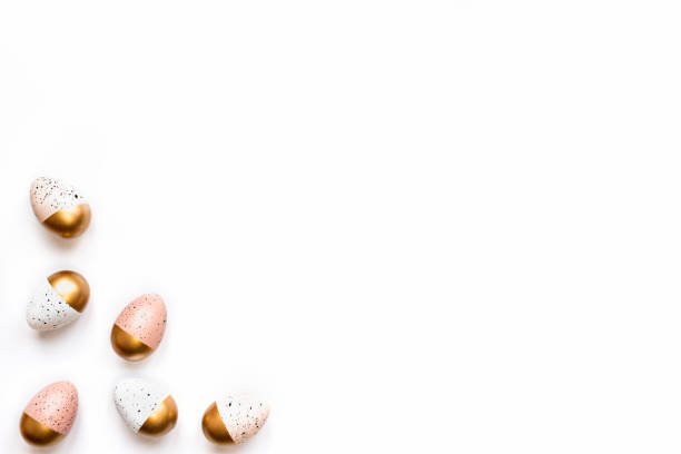 istock Top view of Easter eggs colored with golden paint. Various colorful designs. White background. 1211487557