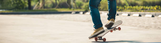 Skateboarder  skateboarding  on parking lot Skateboarder  skateboarding  on parking lot Ollie stock pictures, royalty-free photos & images