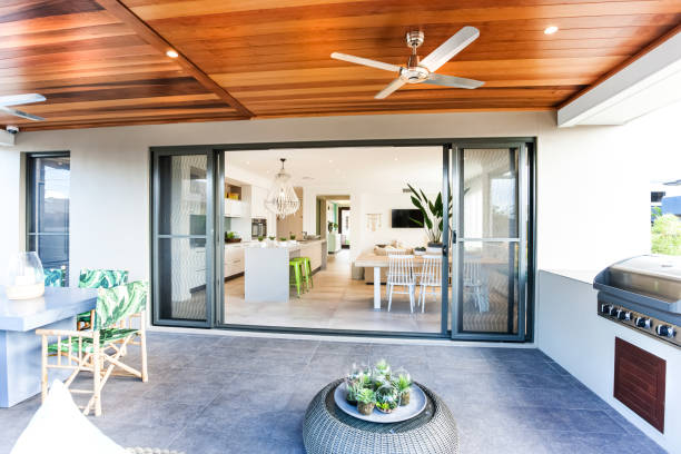 Australian designed home with an outside bbq Stylish terrace dining and barbeque décor with contrasting grey furniture with green chairs and planters for centre table. architectural model photos stock pictures, royalty-free photos & images