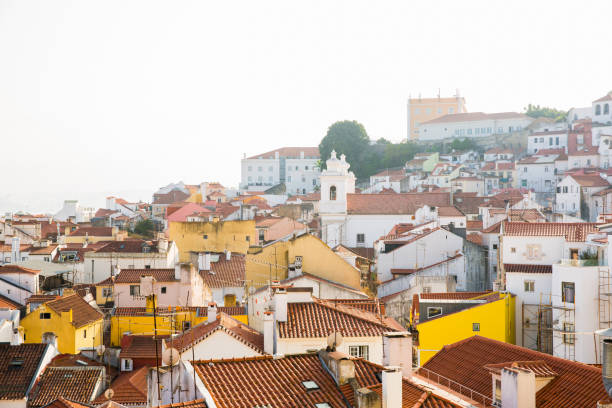 View of buildings along a hillside in the Alfama neighborhood of Lisbon, Portugal