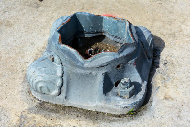 istock Close up. Weathered street lighting base foundation 1211493413