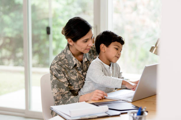 istock Military mom working remote work takes time to play with son 1211494741