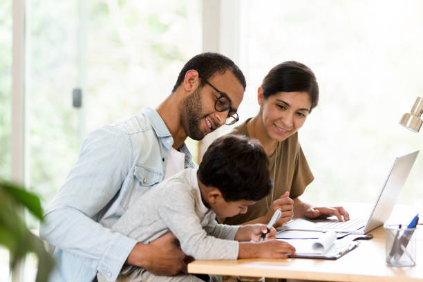 istock Dad holds son in lap; mom looks at drawing 1211494747