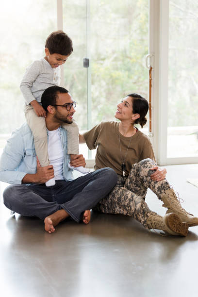 istock While sitting, boy rides on dad's shoulders; mom looks up 1211494756