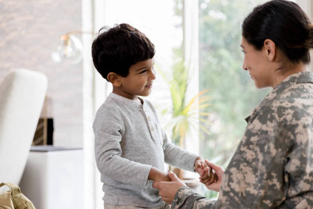istock Soldier mother kneels down to explain deployment to young son 1211494778