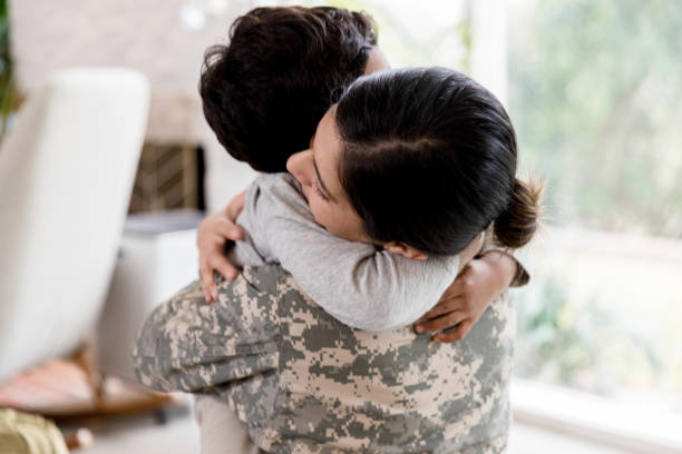 istock Solider mother and young son hug 1211494788