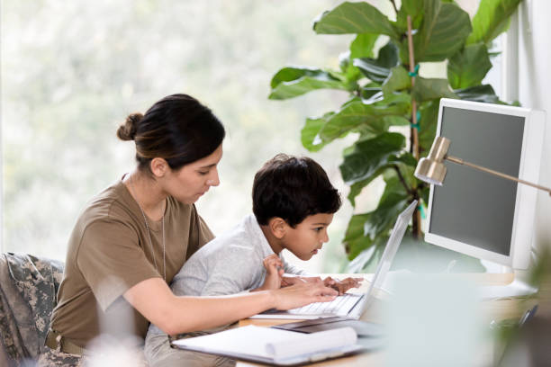 istock Military mom and son enjoy using laptop 1211494800