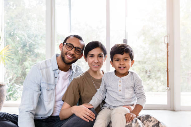 istock Wife leans against husband as son sits in mom's lap 1211494808