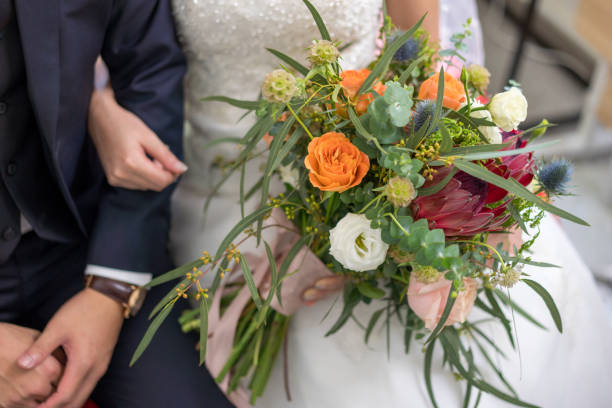 istock Wedding couple hand holding flower bouquet 1211495711
