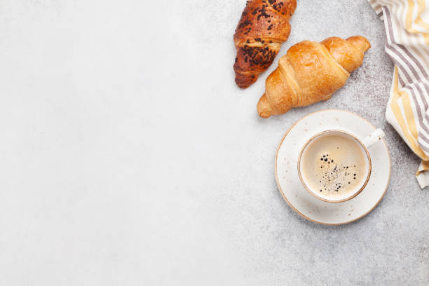 istock Breakfast with coffee and croissant 1211500784